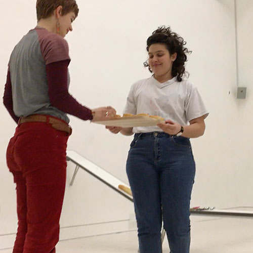 Audience member is taking a piece of bread with jam